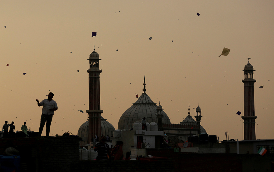 People fly kites from rooftops as they celebrate Independence Day in the Old quaters of Delhi, India. PHOTO: REUTERS