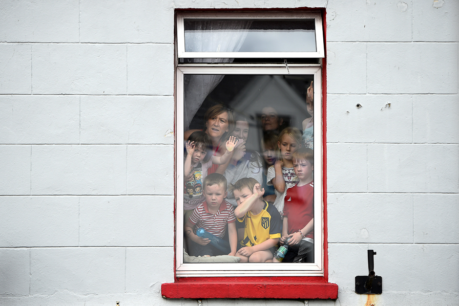 People crowd into a window to see a wild goat paraded through the town before being crowned King Puck for three days in Killorglin, Ireland, PHOTO: REUTERS