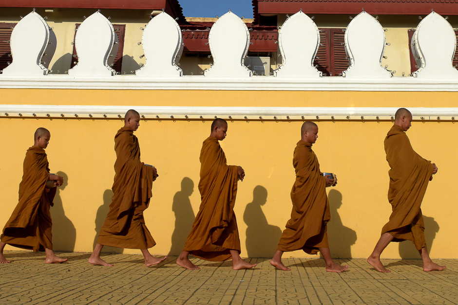 Buddhist monks walk in front of the Royal Palace in Phnom Penh. PHOTO: AFP