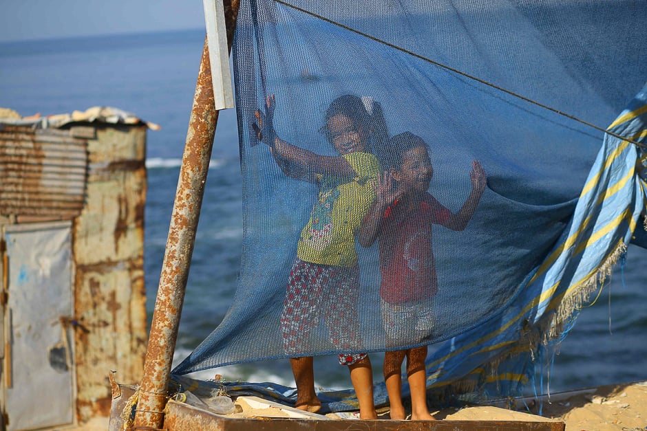 Palestinian girls play next to their homes in Gaza City. PHOTO: AFP