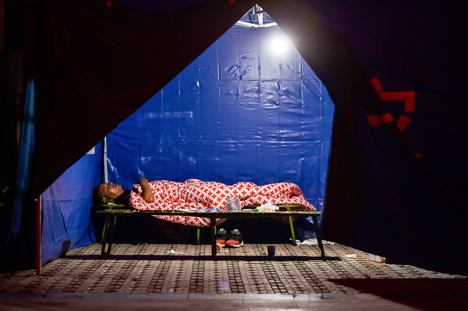 A man sleeping in a tent in Jiuzhaigou in China's southwestern Sichuan province, after an 6.5-magnitude earthquake struck the province late on August 8. PHOTO: AFP