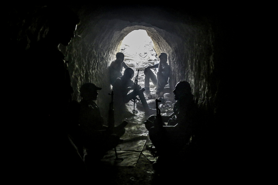 Syrian rebel fighters from the Faylaq al-Rahman brigade hold a position inside a tunnel in Ain Tarma, in the eastern Ghouta area, a rebel stronghold east of the capital Damascus. PHOTO: AFP