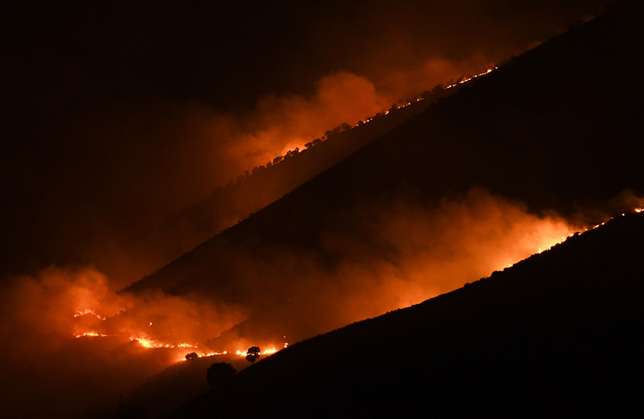 Flames and smoke rise from a forest in fire near Sarande in the Muzina mountain region, southern Albania. PHOTO: AFP