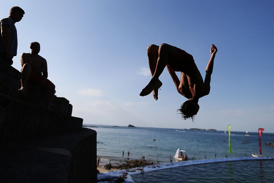 A woman dives into the water at a beach in Dinard, northwestern France. PHOTO: AFP
