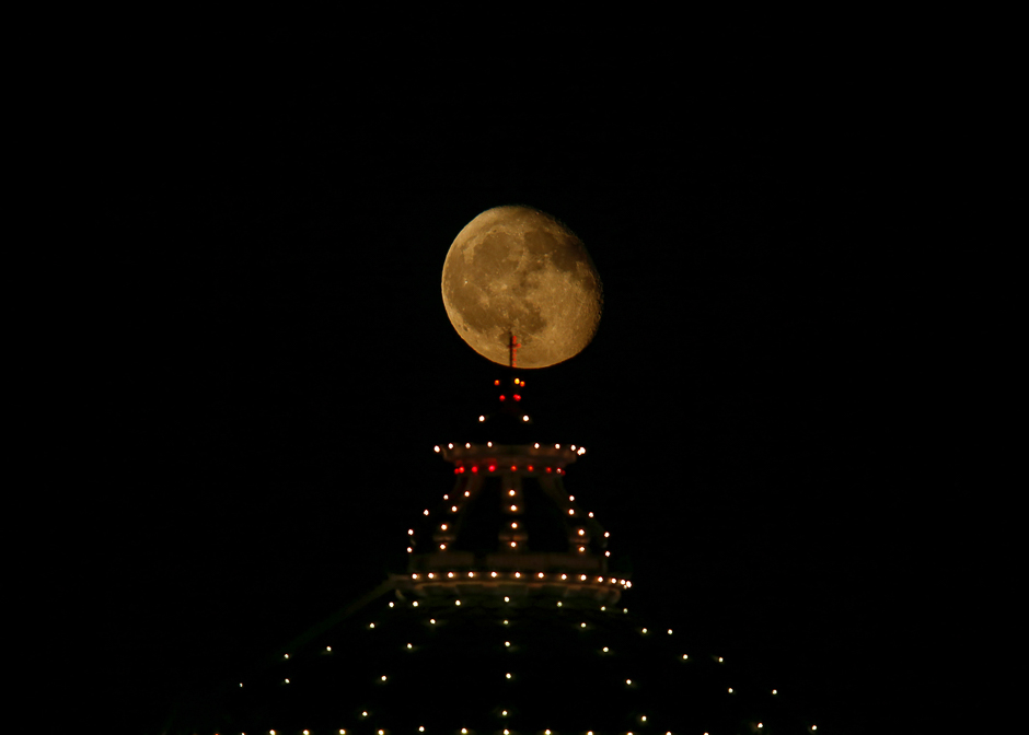 The waning gibbous moon rises behind the dome of the Church of the Assumption of Our Lady, commonly known as the Rotunda of Mosta, during week-long celebrations marking the feast of the Assumption of Our Lady in Mosta, Malta. PHOTO: REUTERS