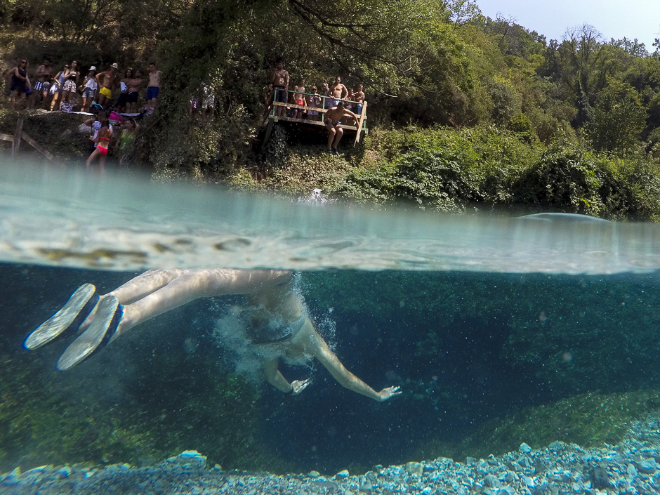 A man swims to cool off in the Blue Eye water spring and natural phenomenon occurring near the city of Sarande. PHOTO: AFP