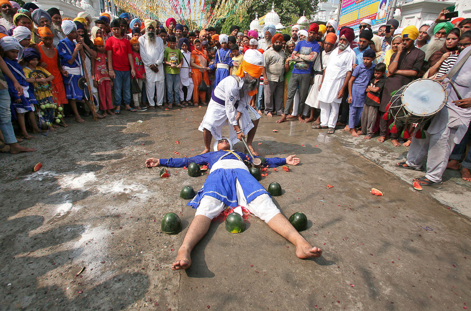 A Sikh man with his eyes covered by a cloth breaks watermelons closely placed around performer as they practise Gatkha, a traditional form of martial art, to mark the 413th anniversary of the installation of the Guru Granth Sahib, in Amritsar, India. PHOTO: REUTERS