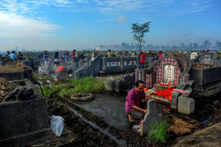 Ethnic Chinese Indonesians visit their ancestral graves at the Kubu Raya district cemetery in West Kalimantan. PHOTO: AFP