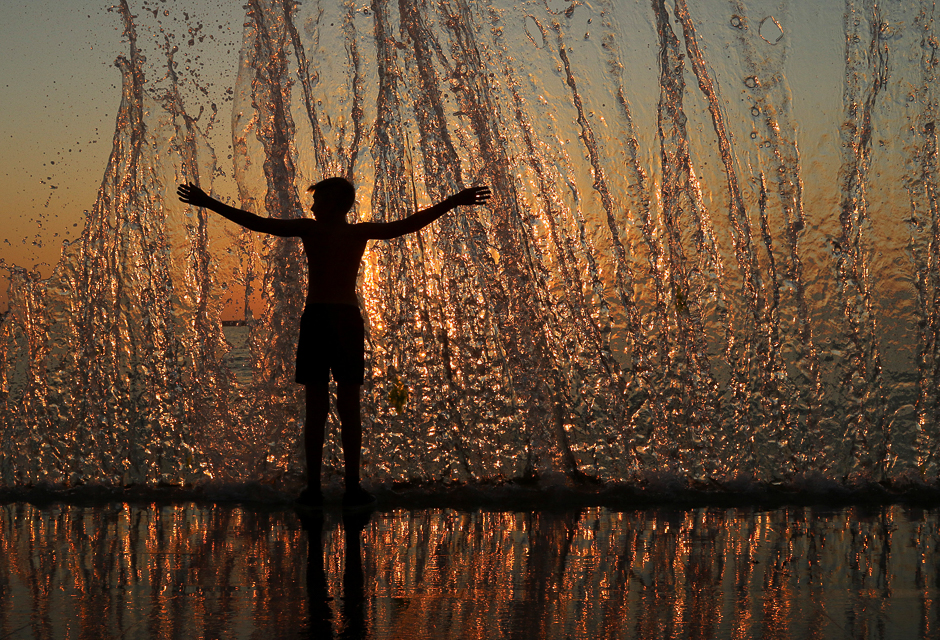 A boy enjoy the waves during sunset on an embankment in the Black Sea port of Sevastopol, Crimea. PHOTO: REUTERS