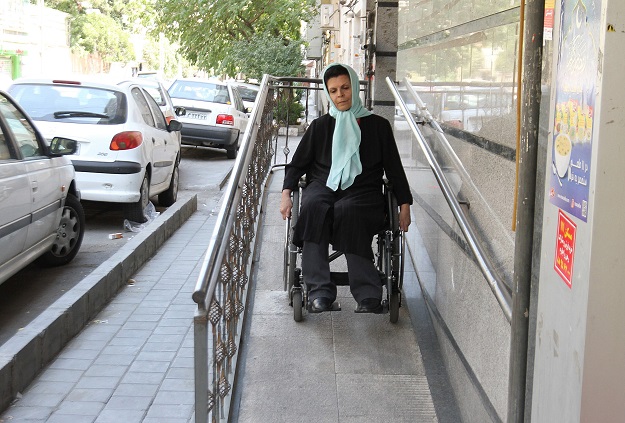 Iranian Fatemeh Nikbakht, who lost the use of her legs in an accident in the 1990s and today runs the Spinal Cord Injury Association, goes down a ramp in her wheelchair on August 1, 2017 in Tehran. PHOTO: AFP