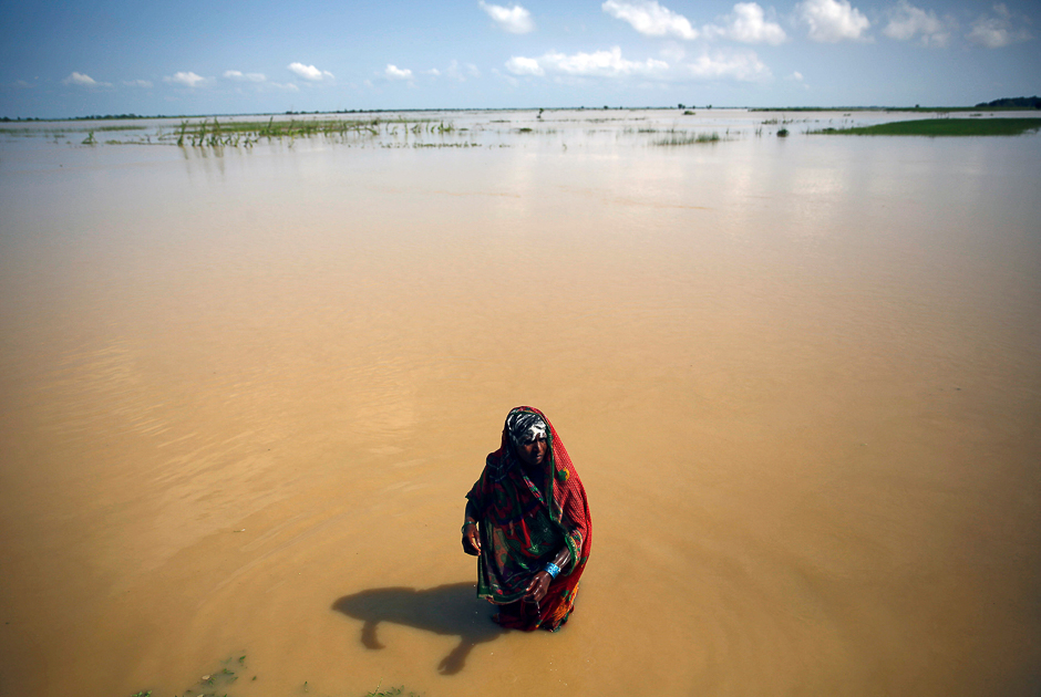 A flood victim washes herself at the flood-affected area in Saptari District, Nepal. PHOTO: REUTERS
