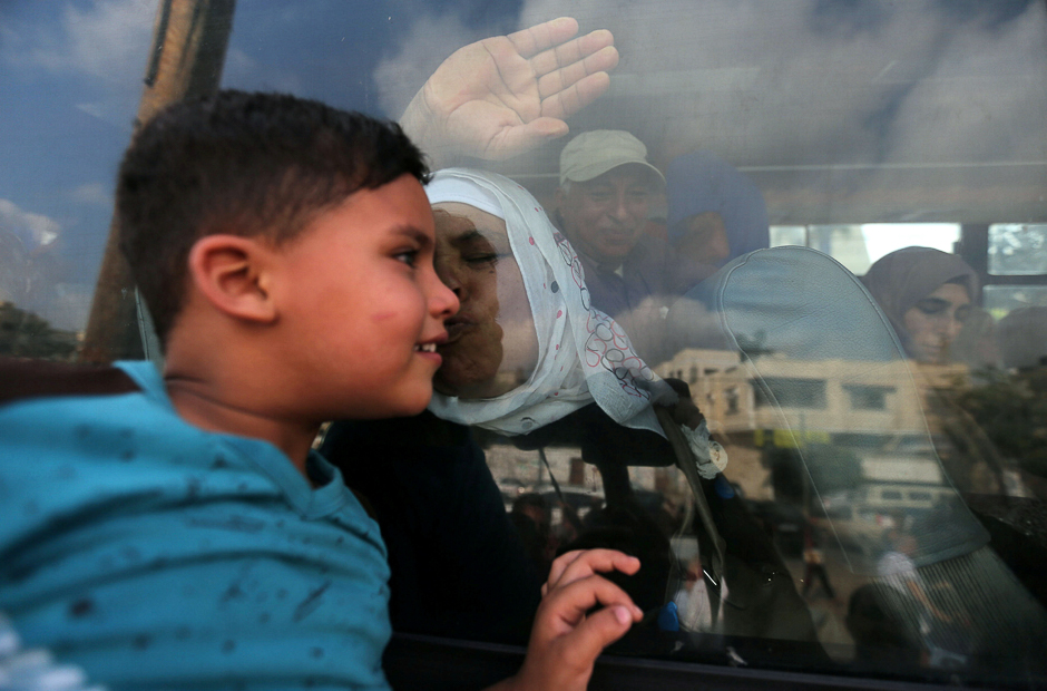 A Palestinian woman kisses her grandson through the window of a bus before she leaves for the annual Haj pilgrimage in Makkah, in Khan Younis in the southern Gaza Strip. PHOTO: REUTERS