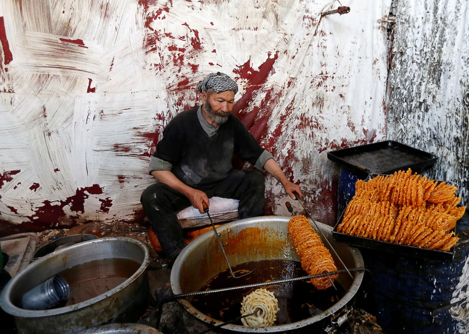 A man makes traditional Jelabi sweets at a small traditional factory ahead of the Eidul Azha in Kabul, Afghanistan. PHOTO: REUTERS