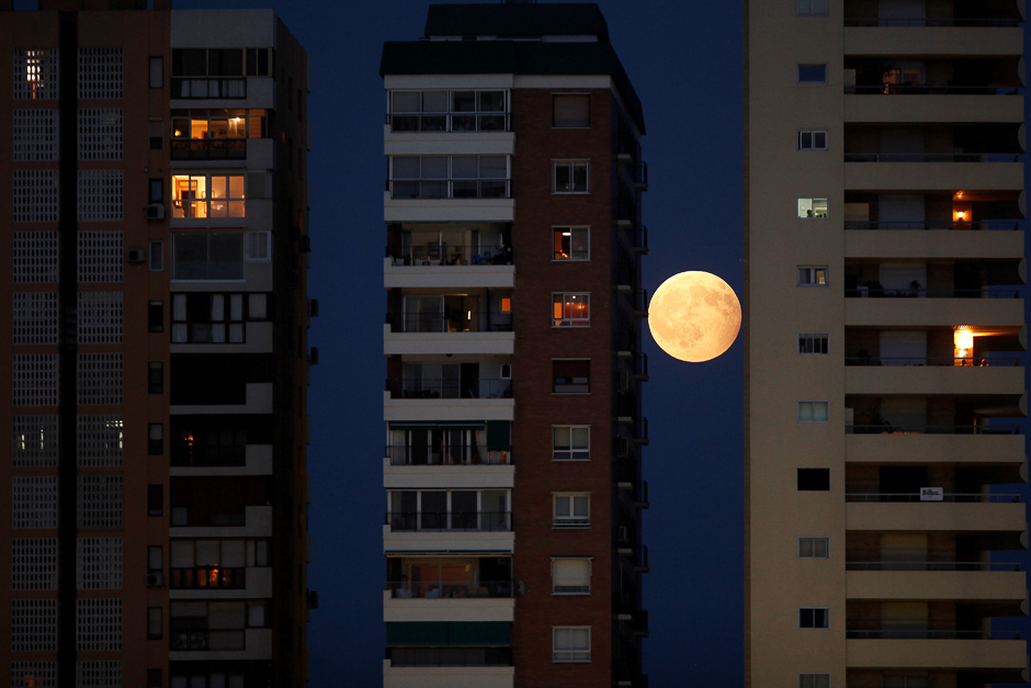 The rising moon is seen during a partial lunar eclipse between buildings in Malaga, southern Spain. PHOTO: REUTERS