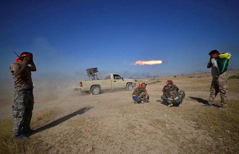 Shia Popular Mobilisation Forces (PMF) launch a rocket towards Islamic State militants on the outskirts of Tal Afar, Iraq. PHOTO: REUTERS