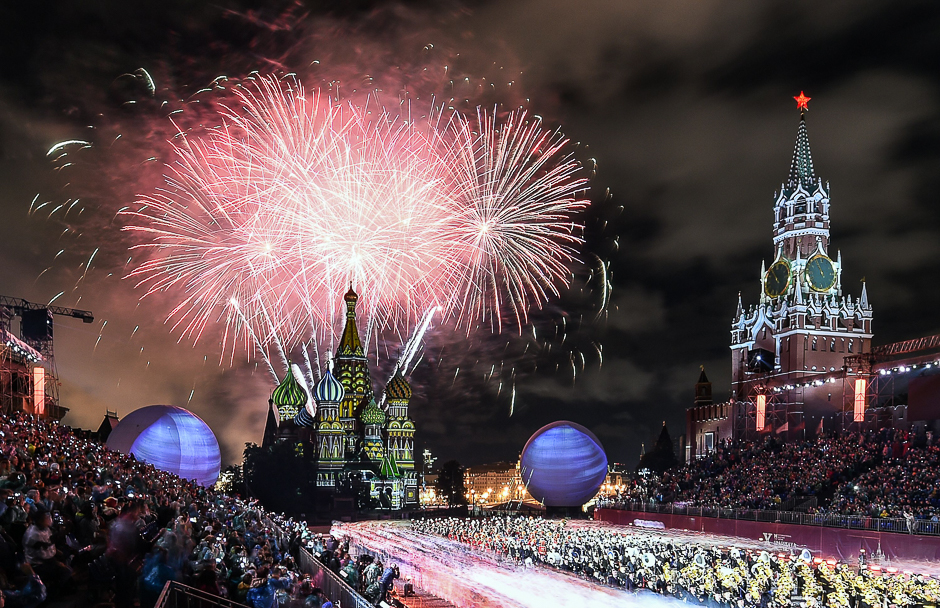People look at fireworks above Saint Basil's Cathedral during the 'Spasskaya Tower' international military and music festival on the Red Square in Moscow. PHOTO: AFP
