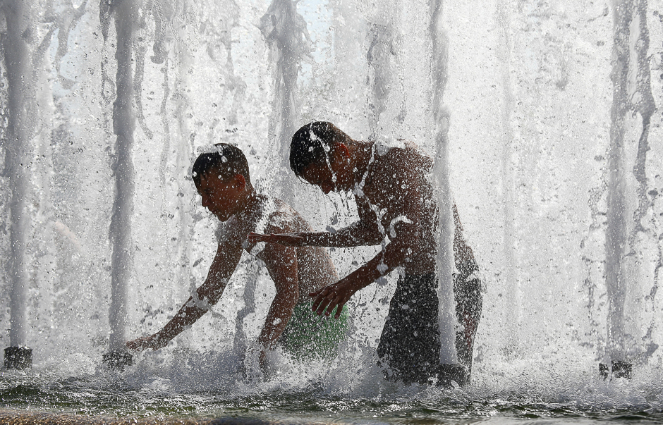 Boys cool themselves in a fountain during hot summer day in central Minsk, Belarus. PHOTO: REUTERS
