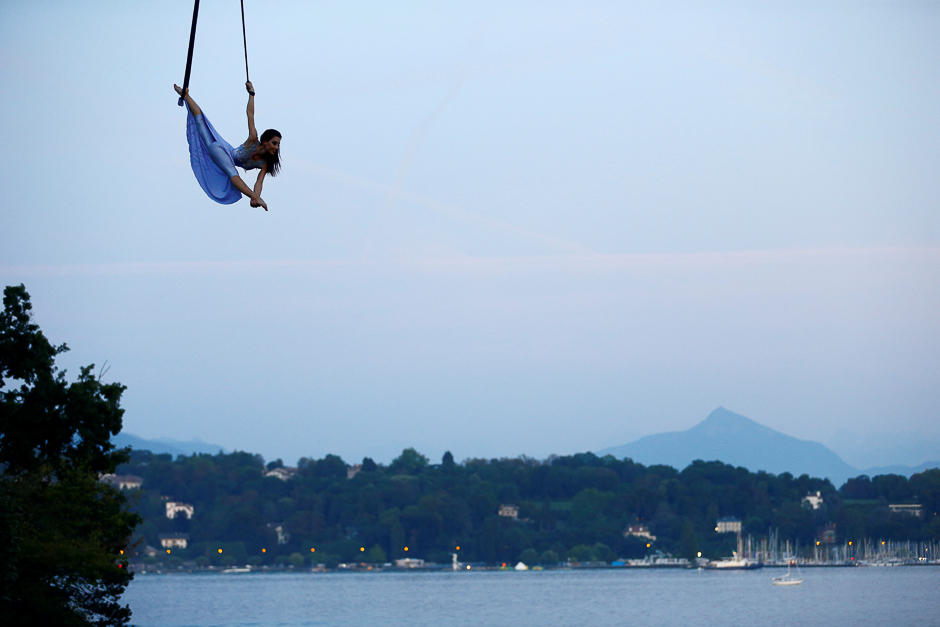 Russian acrobat Ekaterina Stepanova, currently on show with Swiss National Circus Knie in Geneva, performs under a hot air balloon next to Lake Leman in Geneva, Switzerland. PHOTO: REUTERS