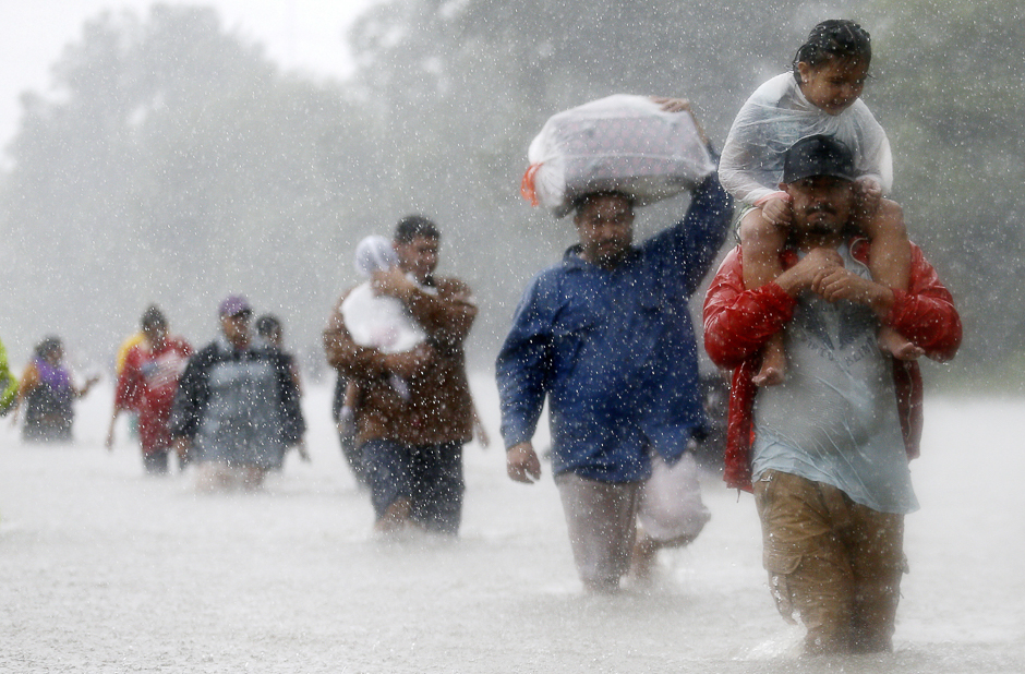 Residents wade through flood waters from Tropical Storm Harvey in Beaumont Place, Houston, Texas, US. PHOTO: REUTERS