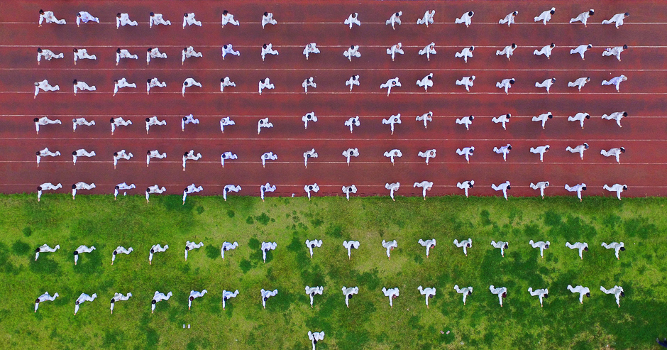 This photo taken using a drone shows people performing Tai Chi as part of a National Fitness Day event in Rongan in China's southwestern Guizhou province. PHOTO: AFP