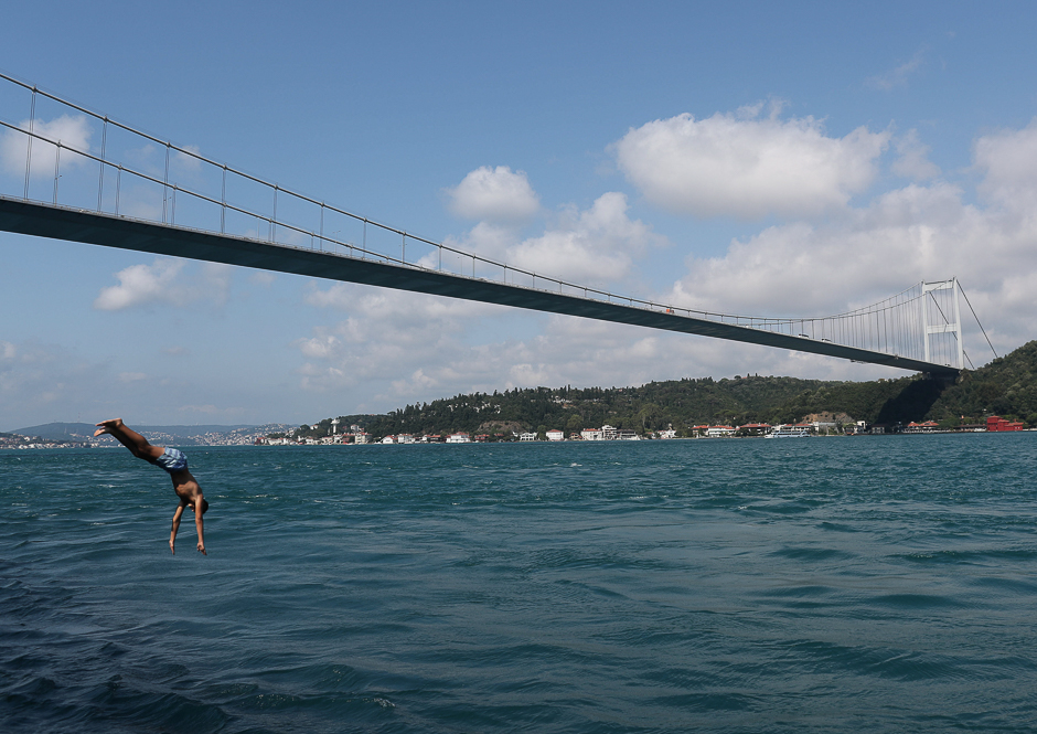 A boy jumps into the waters of the Bosphorus in Istanbul, Turkey. PHOTO: REUTERS