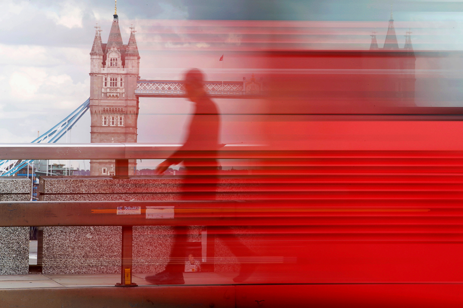 A man walks across London Bridge behind a barrier to prevent traffic mounting the pavement in London, Britain. PHOTO: REUTERS