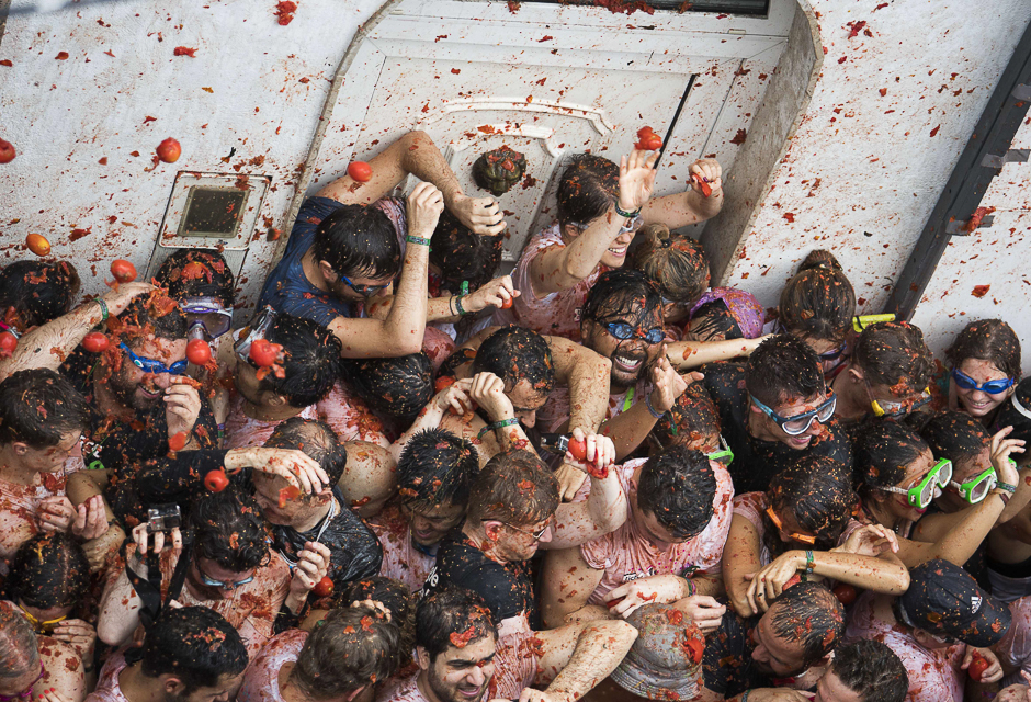 Revellers covered in tomato pulp participate in the annual 
