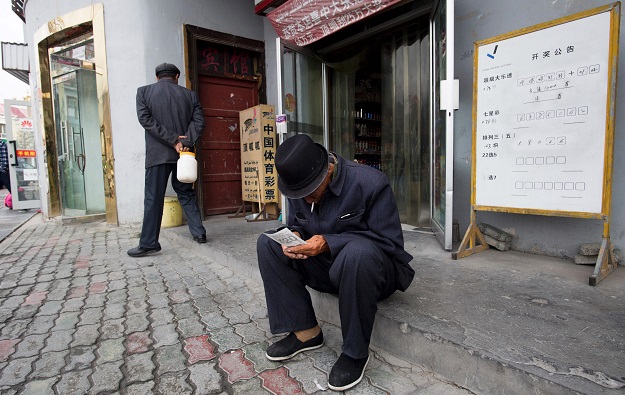 A man looking at his lottery ticket in Tashkurgan, China's western Xinjiang province. PHOTO: AFP