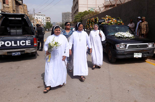 Nuns walk with flowers to attend the funeral of Ruth Pfau. PHOTO: REUTERS