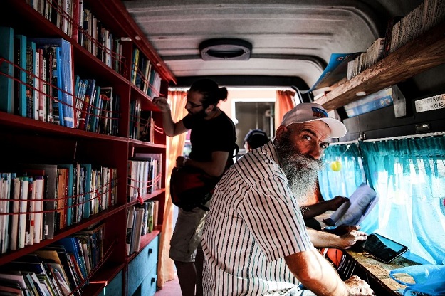 4 Inside the library van in Athens are books in English, Greek, Arabic, French, Kurdish and Farsi -- Agatha Christie is a favourite Inside the library van in Athens are books in English, Greek, Arabic, French, Kurdish and Farsi -- Agatha Christie is a favourite. (AFP Photo/LEFTERIS PARTSALIS)