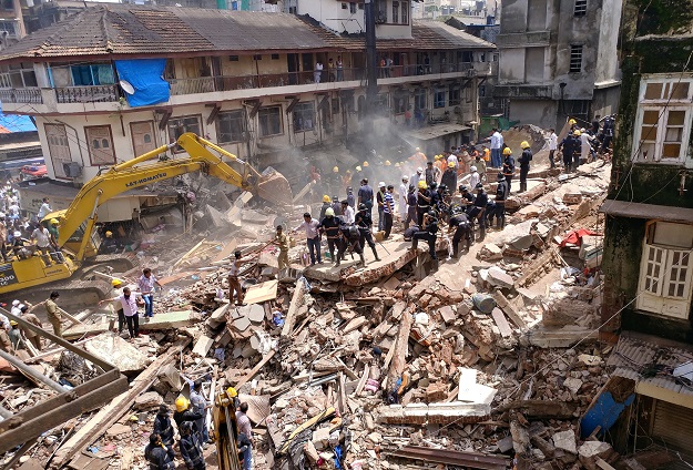  Firefighters and rescue workers search for survivors at the site of a collapsed building in Mumbai, India. PHOTO: REUTERS
