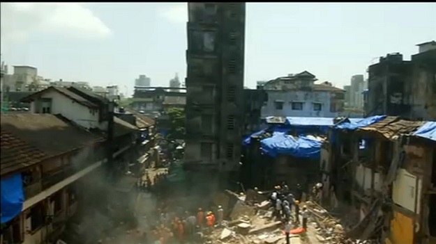  People and rescue personnel are seen after a building collapsed in Mumbai, India in this still frame taken from video. PHOTO: REUTERS