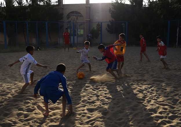 Afghan youths play beach football at Ghazi stadium in Kabul. PHOTO: AFP