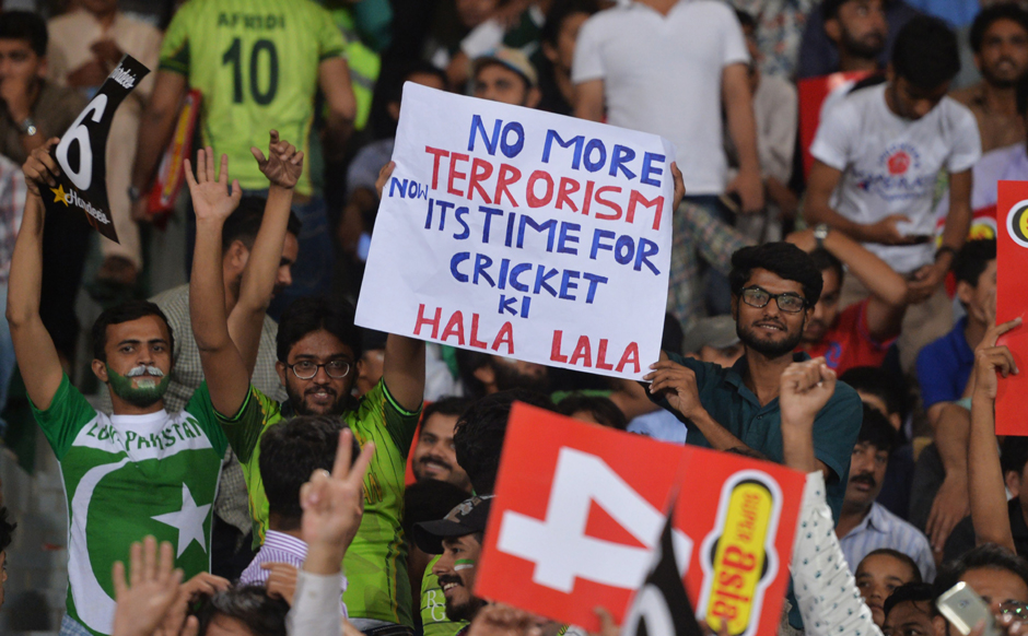 Pakistani spectators hold placards during the match. PHOTO: AFP