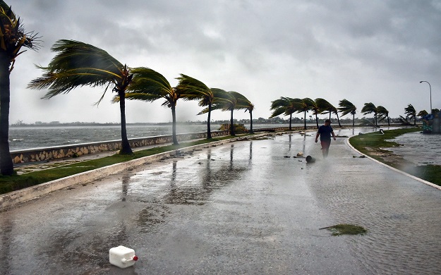 A man walks against heavy winds after the passage of Hurricane Irma, at Caibarien, Villa Clara province, 330km east of Havana. PHOTO: AFP