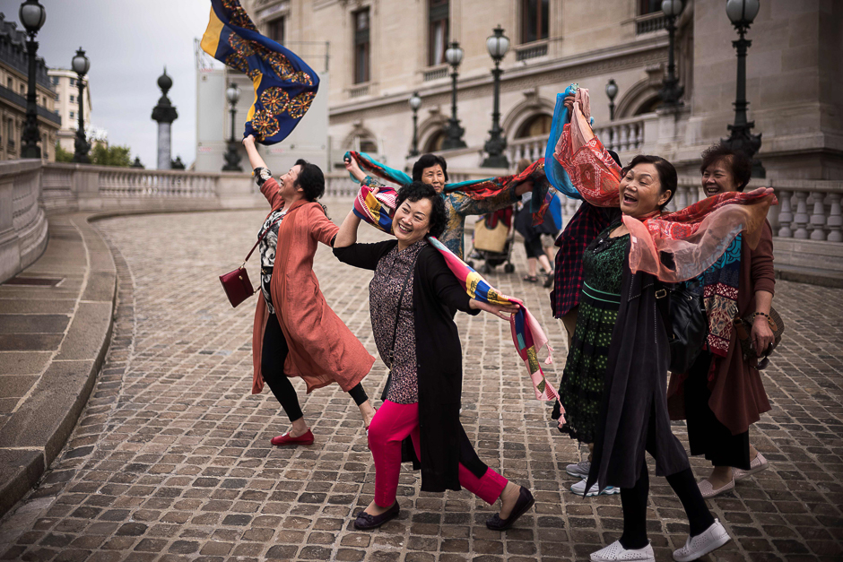 Asian tourists pose for pictures in front of the Opera Garnier in Paris. PHOTO: AFP