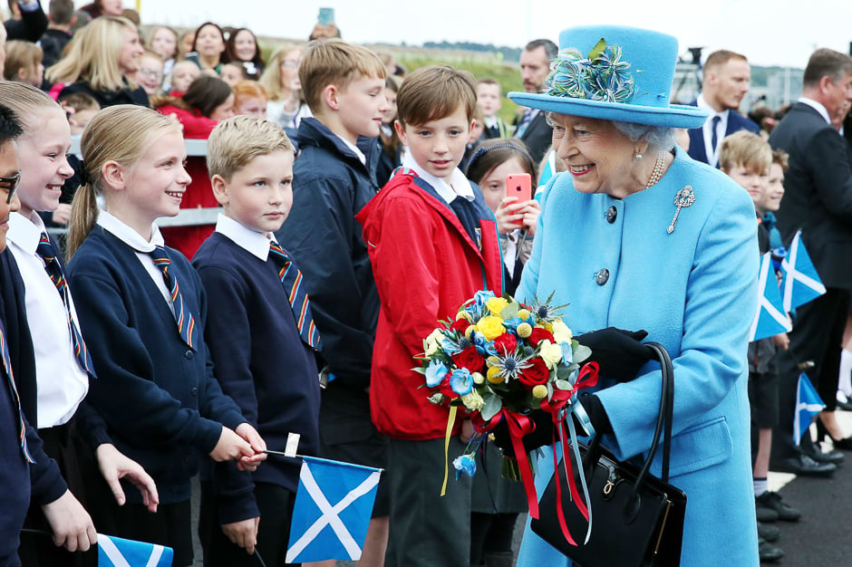 Queen Elizabeth II meets school children during the official opening ceremony for the Queensferry Crossing, a new road bridge spanning the Firth of Forth from Queensferry to North Queensferry, in Queensferry, west of Edinburgh. PHOTO: AFP