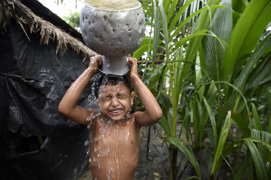 A young Rohingya refugee washes himself at the Jalpatoli refugee camp in the no-man's land area between Myanmar and Bangladesh, near Gumdhum village in Ukhia. PHOTO: AFP