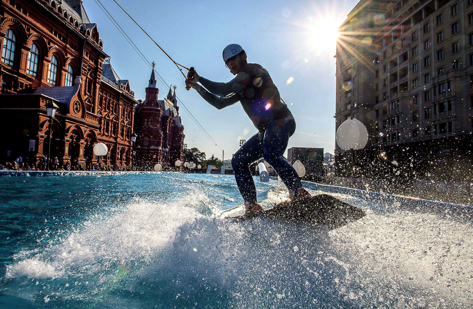 A man rides a wakeboard in a giant pool set next to the Red Square and the Kremlin in Moscow. PHOTO: AFP