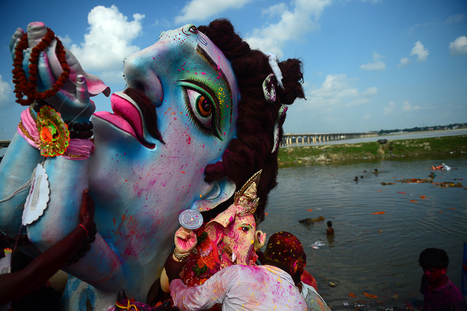 Indian Hindu devotees carry an idol of the elephant-headed Hindu deity Ganesha for immersion in a temporary pond near Sangam in Allahabad. PHOTO: AFP