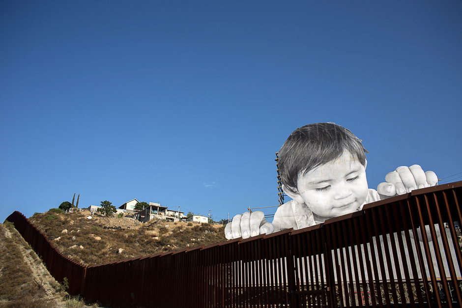 View of an artwork by French artist JR on the US-Mexico border in Tecate, California, United States. PHOTO: AFP