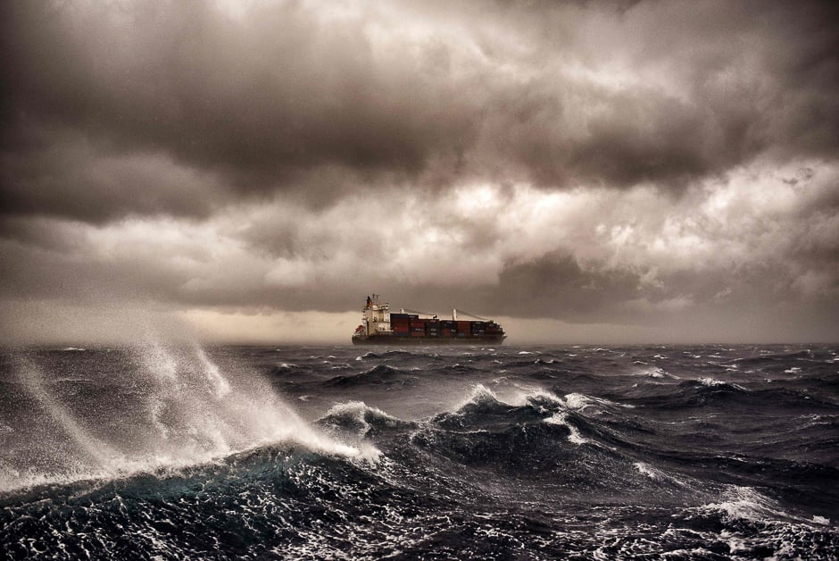 A cargo ship sails on the Mediterranean sea during a thunderstorm some 20 naughtical miles from Malta. PHOTO: AFP