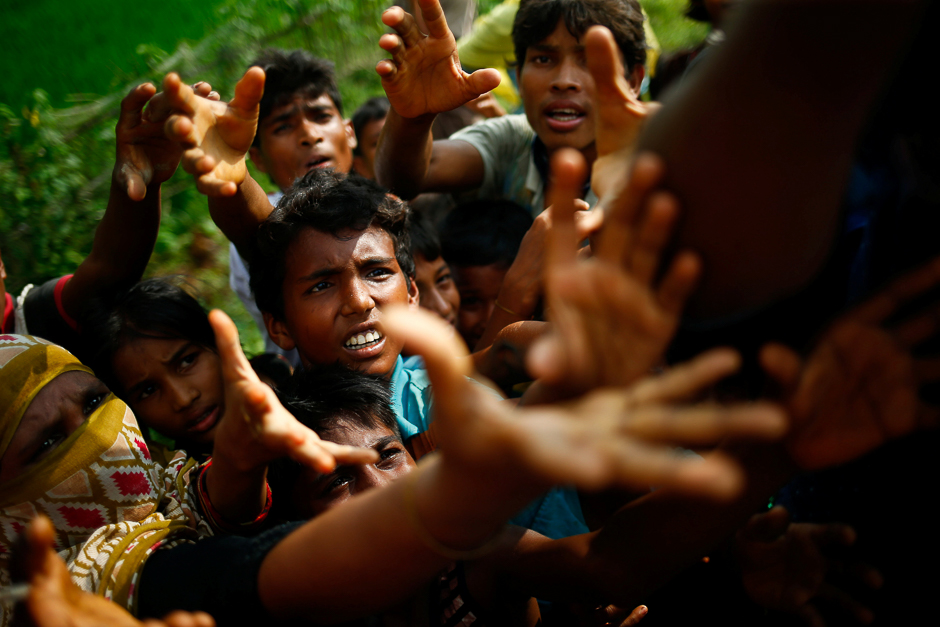 Rohingya refugees stretch their hands for food near Balukhali in Cox's Bazar, Bangladesh. PHOTO: REUTERS