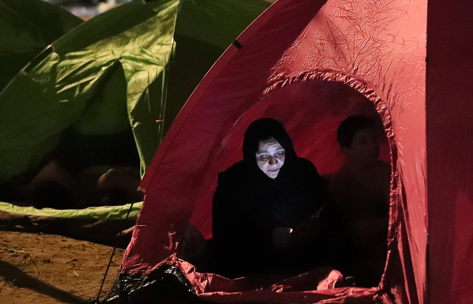 A pilgrim checks her mobile phone as she rests in a tent near Mount Arafat. PHOTO: AFP
