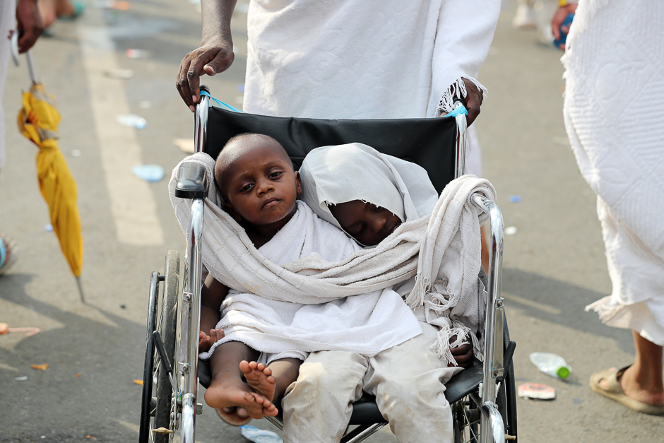 Two pilgrim children are seemn sitting in a wheelchair near Mount Arafat. PHOTO: AFP