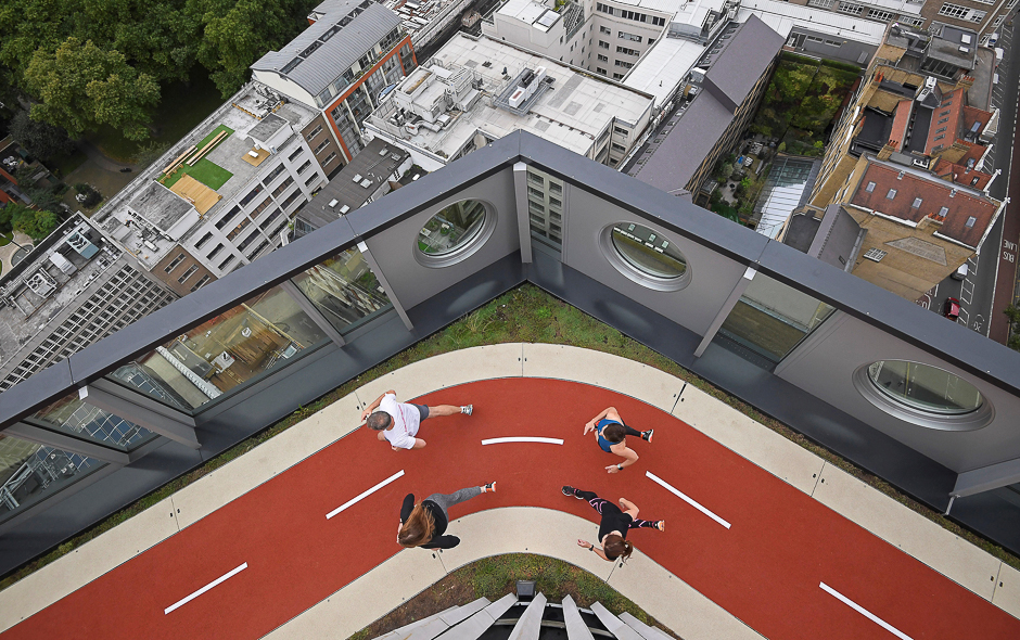 Workers pose as they run round a track, unveiled as the highest running track in London, at the White Collar Factory in the 'tech belt' hub near Old Street in London. PHOTO: REUTERS