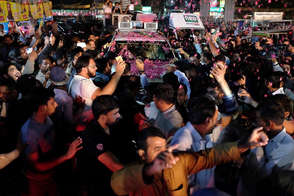 Maryam Nawaz, the daughter of Pakistan's former Prime Minister Nawaz Sharif, rides in a car being showered with rose petals at a rally in Lahore. PHOTO: REUTERS