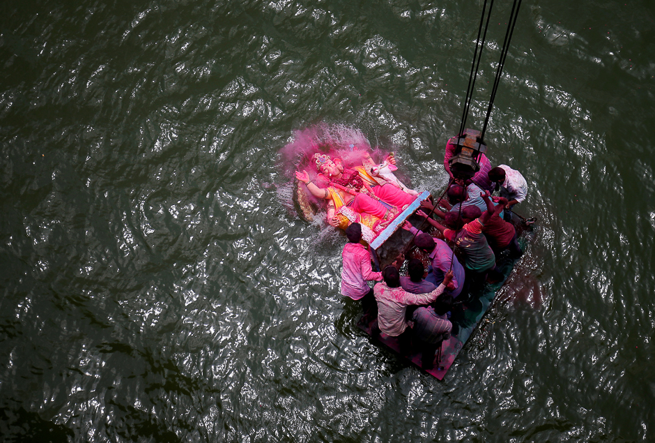 Devotees immerse an idol of the Hindu god Ganesh, the deity of prosperity, into the Sabarmati river on the last day of the Ganesh Chaturthi festival in Ahmedabad, India. PHOTO: REUTERS