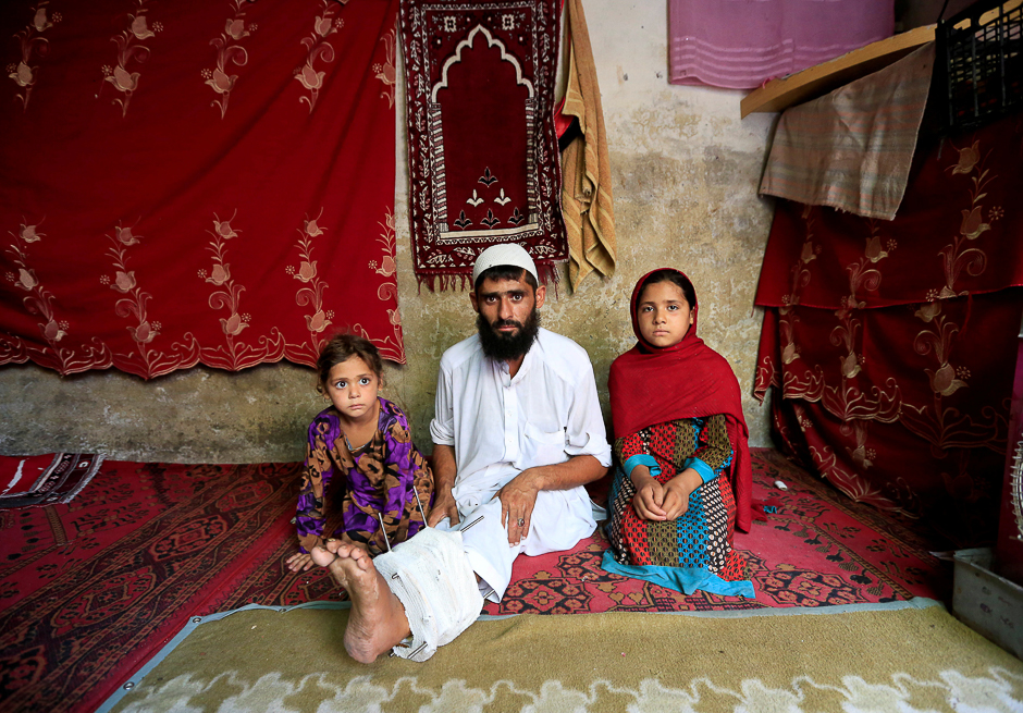 Mehrullah Safi, 28, a disabled Afghan National Army (ANA) soldier, sits with his children at their house in Jalalabad province, Afghanistan. PHOTO: REUTERS