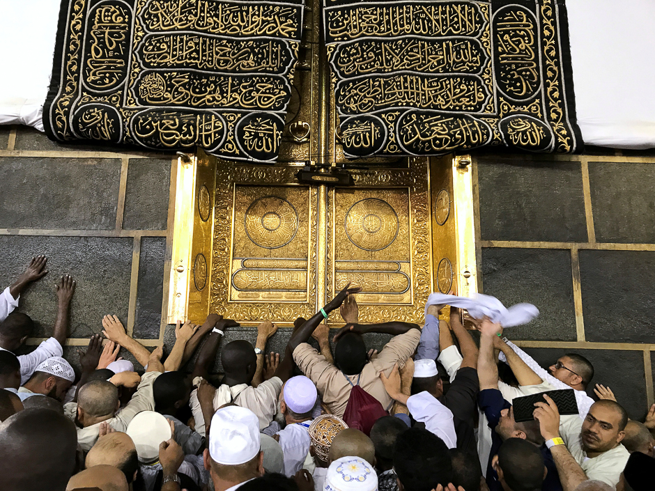 Pilgrims touch the Holy Kaaba at the Grand mosque ahead of the Haj. PHOTO: REUTERS